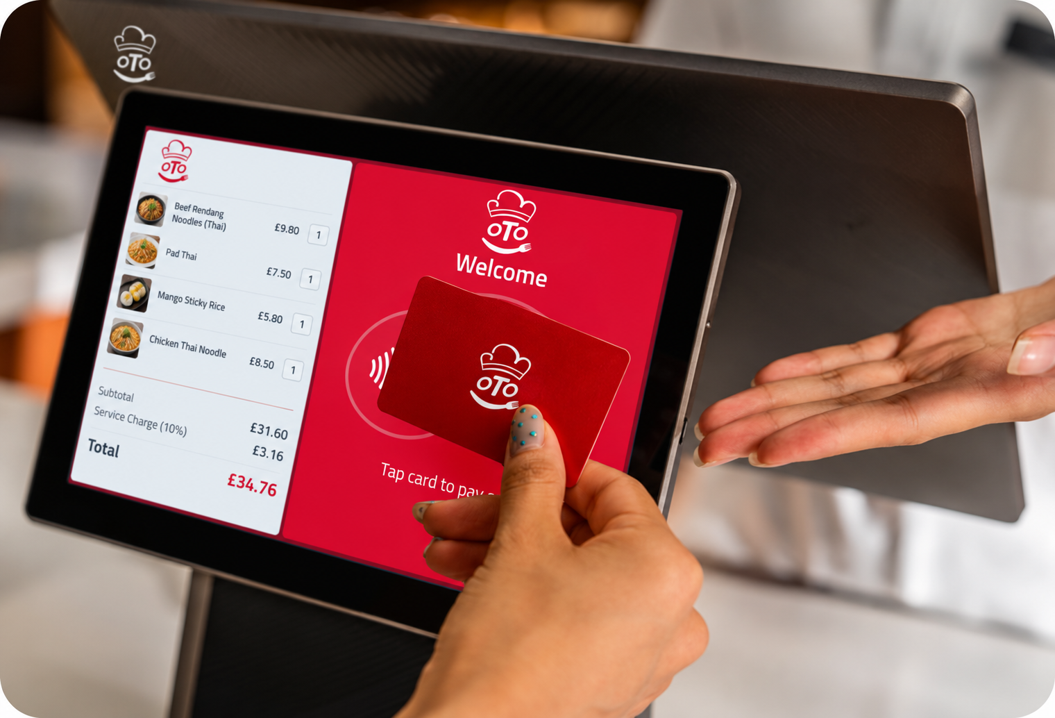 An OTO-branded counter device with two screens showing ordering and payment on a café counter